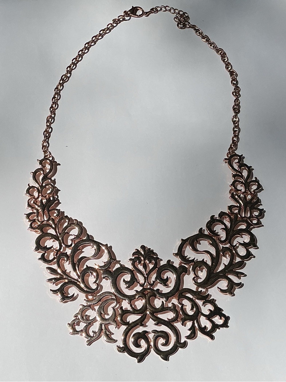 Baroque-inspired Filigree bib necklace in a rose gold tone.